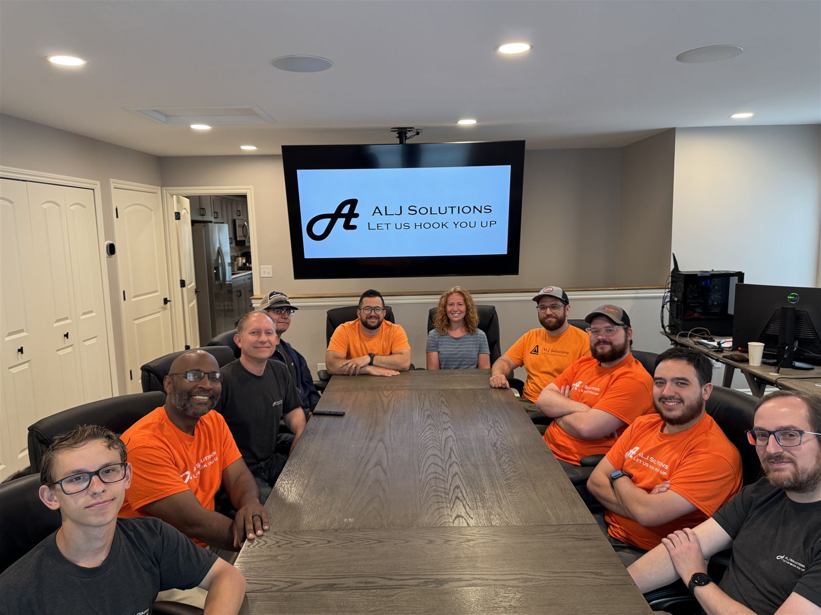 The ALJ Solutions team around a conference table